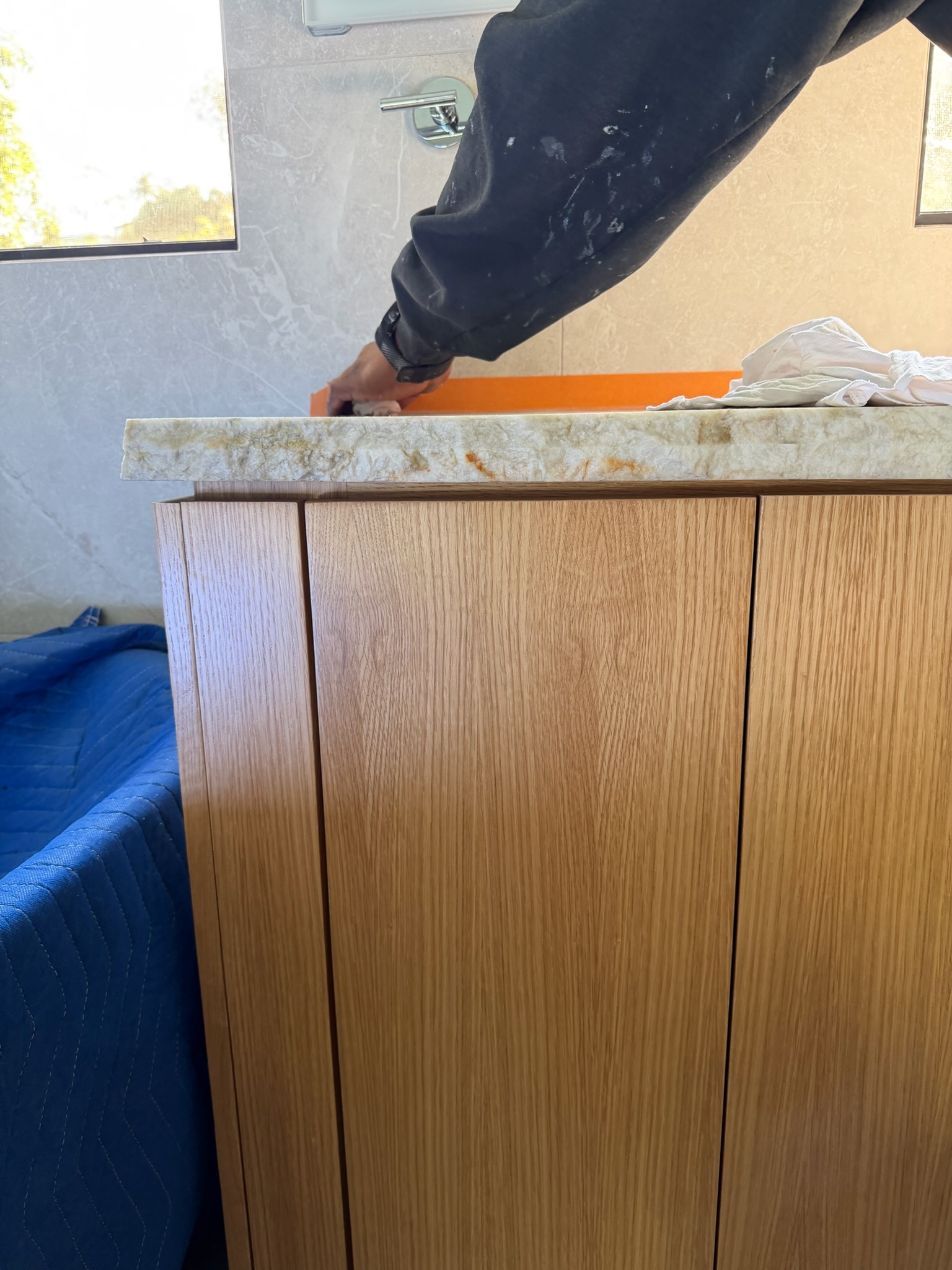 White oak bathroom cabinetry and stone edge during installation